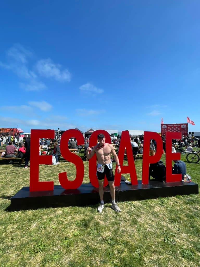 Posing at ESCAPE sign post-race