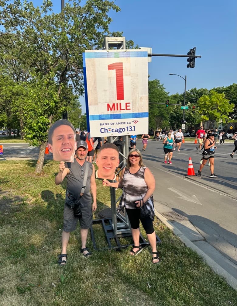 Parents with big head cutouts at Chicago 13.1